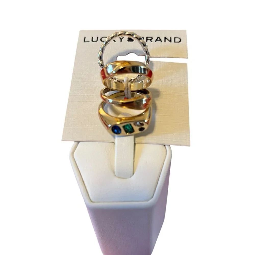 Two Tone Jeweled Ring Stack Set. 4 Rings in total. 3 in Gold Tone, 1 in Silver.